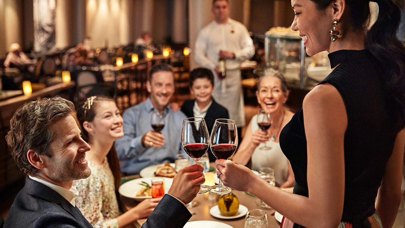 Family and friends celebrating together over dinner